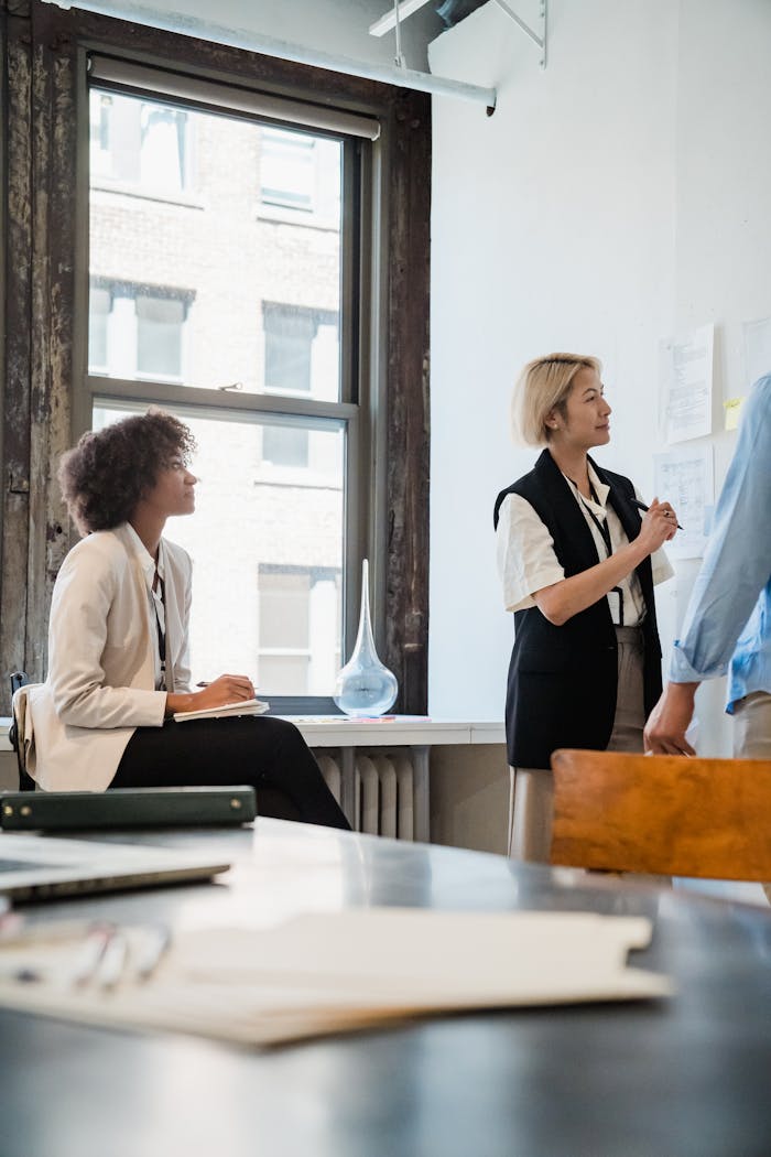 Professional team collaborating on a project in a well-lit office space.